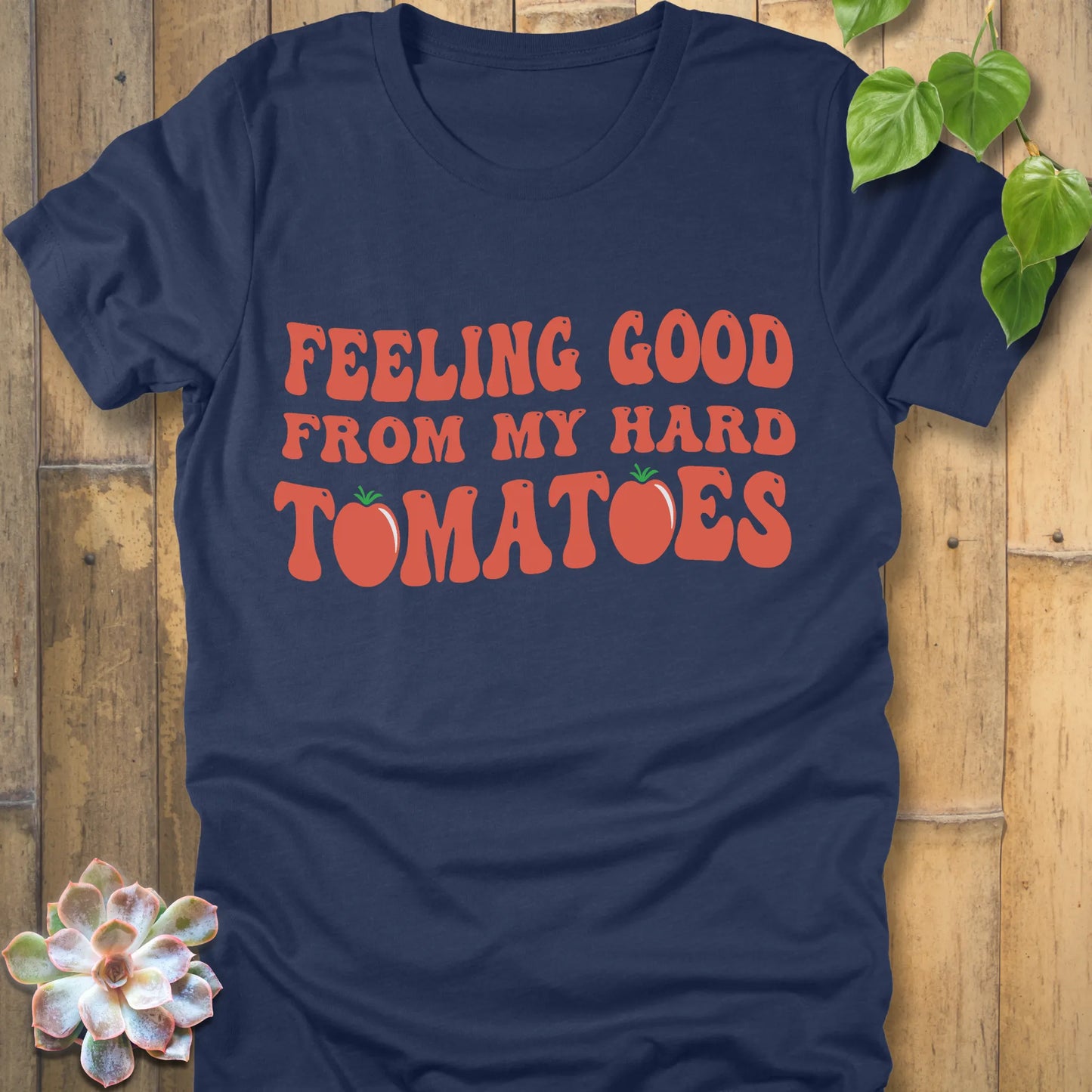 Heather navy t-shirt featuring the design "Feeling Good from my hard tomatoes" printed in bold orange letters
