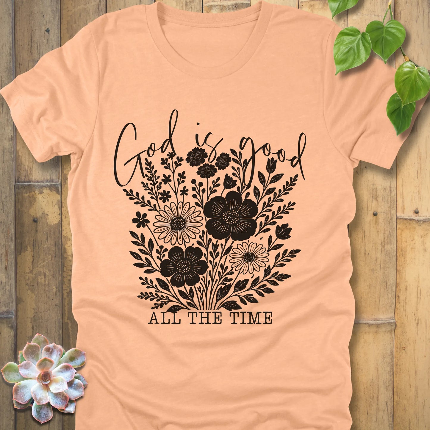 Heather peach t-shirt featuring the design God is Good printed with flowers in a soft floral style