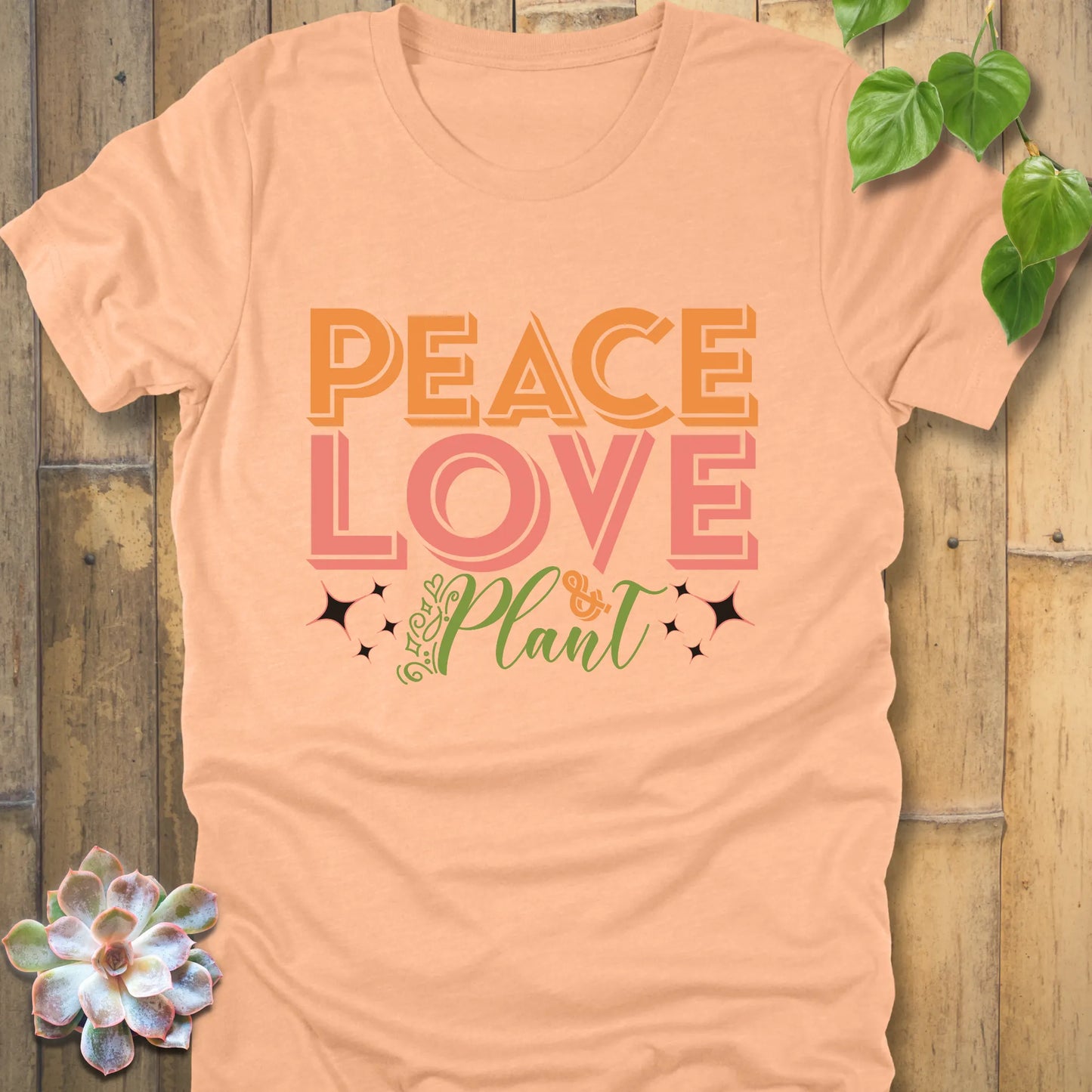 Heather peach t-shirt featuring the design Peace Love Plant printed in bold letters, trendy plant lover shirt