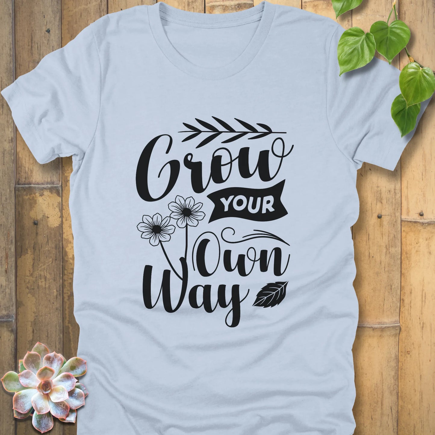 Light blue cotton t-shirt featuring the positive message Grow your own way, breathable casual wear graphic tee.