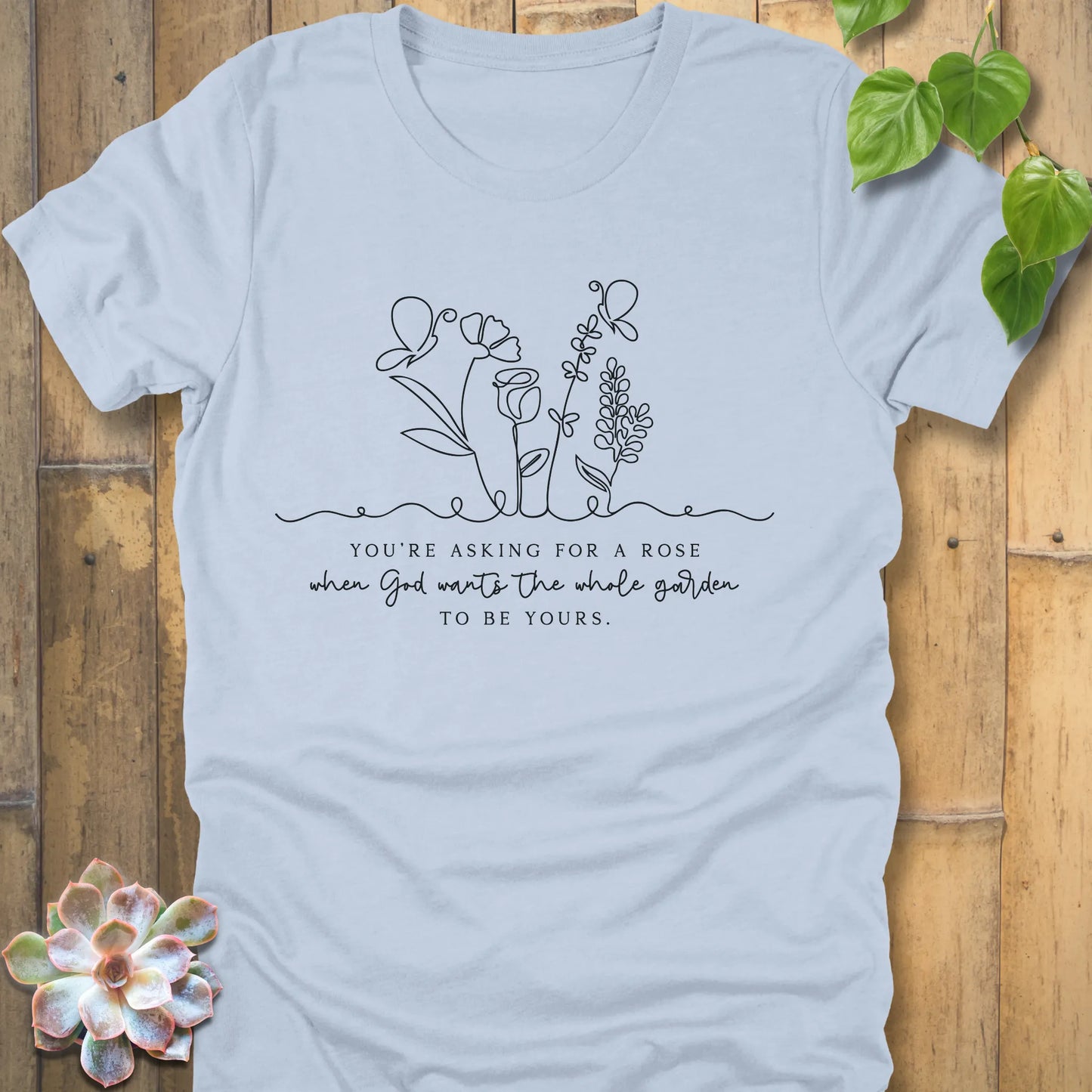 Light blue t-shirt featuring the design Asking for a rose, printed in black letters, trendy summer cotton tee