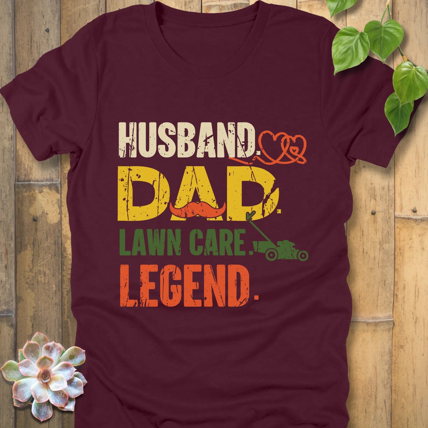 Maroon t-shirt featuring the design "Husband, Dad lawn care legend" printed in bold letters