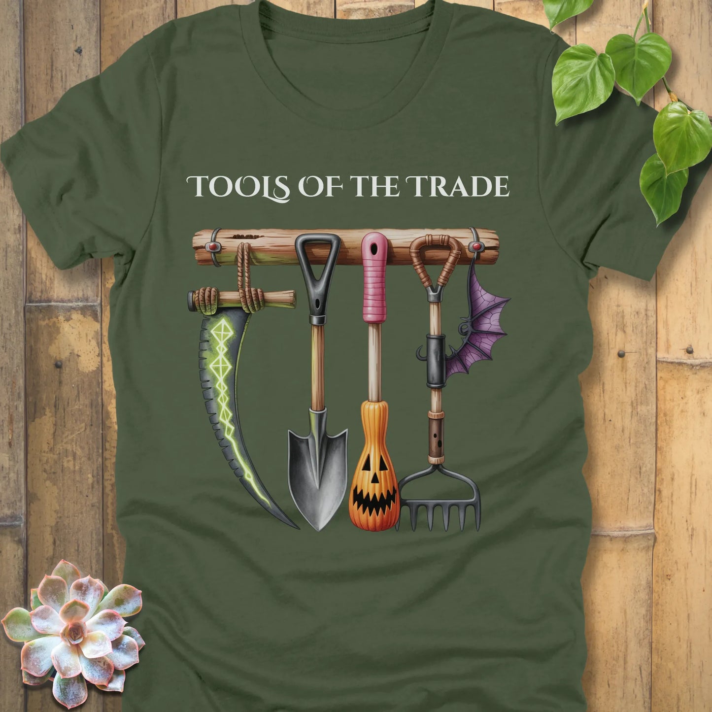 Military Green t-shirt featuring the design Tools of the Trade printed in bold letters with a halloween tools