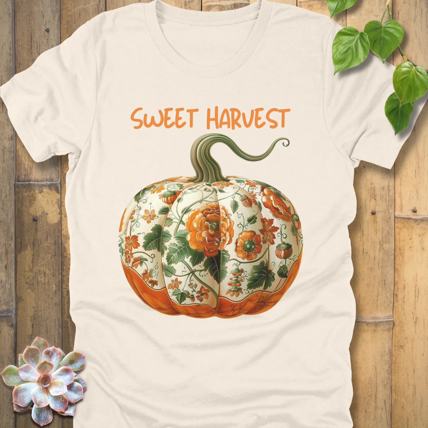 Natural t-shirt featuring the design Sweet Harvest printed in bold orange letters and a halloween pumpkin design