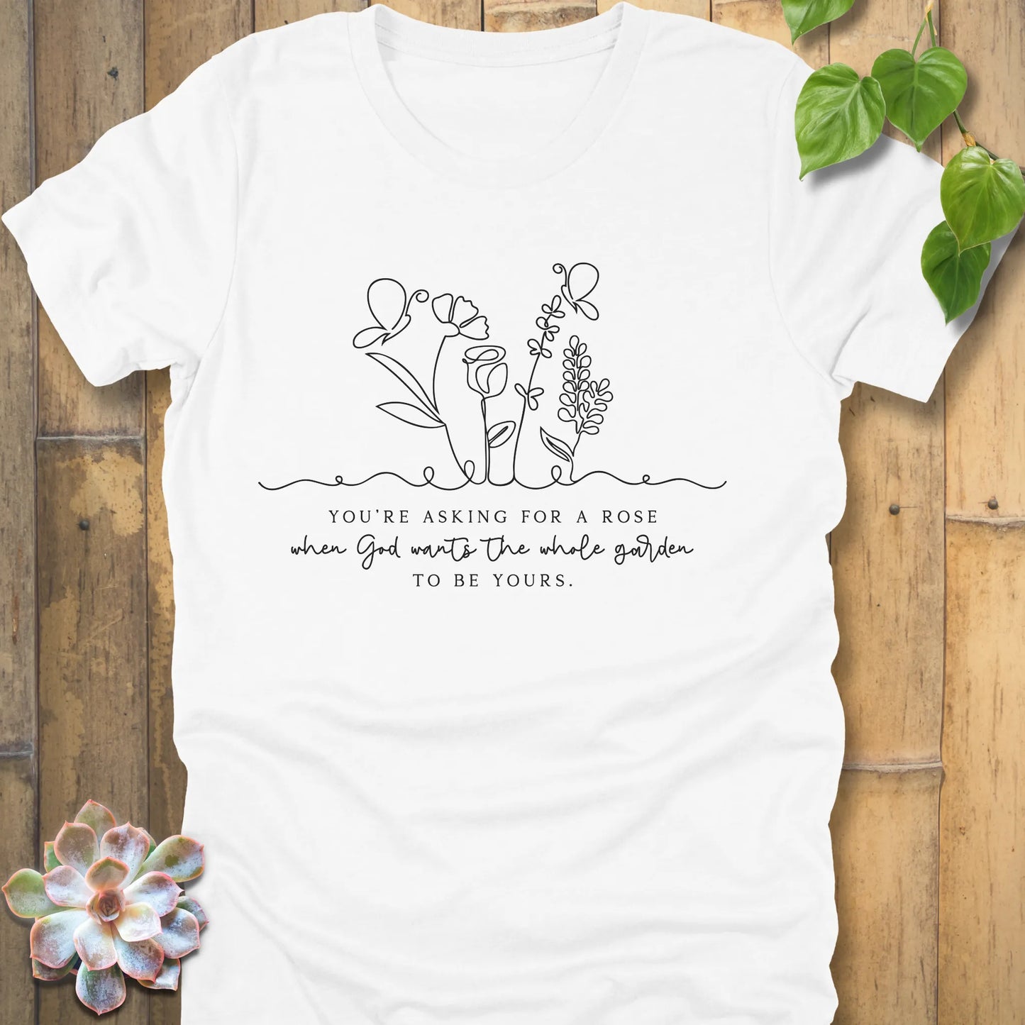 White t-shirt featuring the design Asking for a rose, printed in black letters, casual floral graphic tee