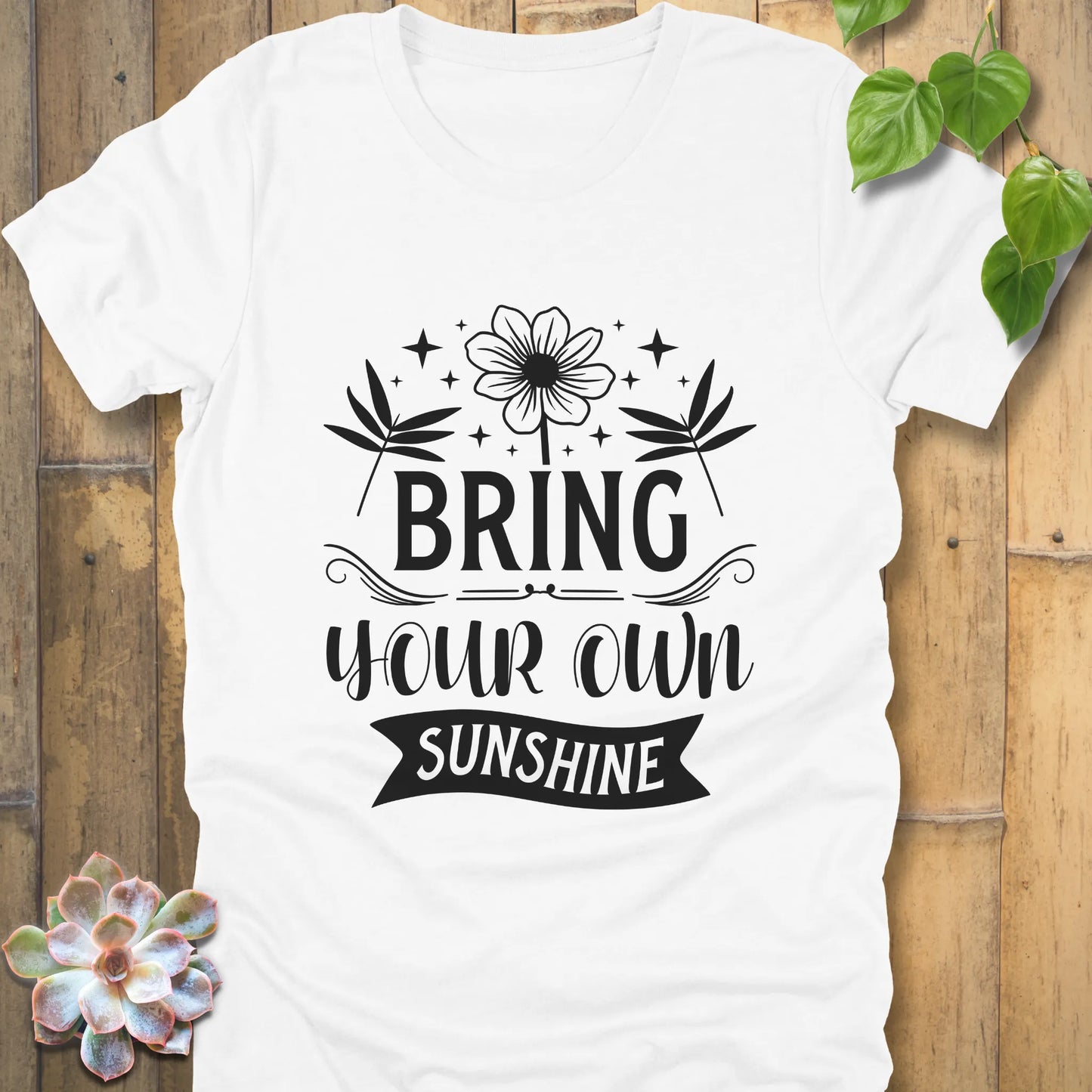 White t-shirt featuring the design "Bring Your Own Sunshine" printed in black letters and flower
