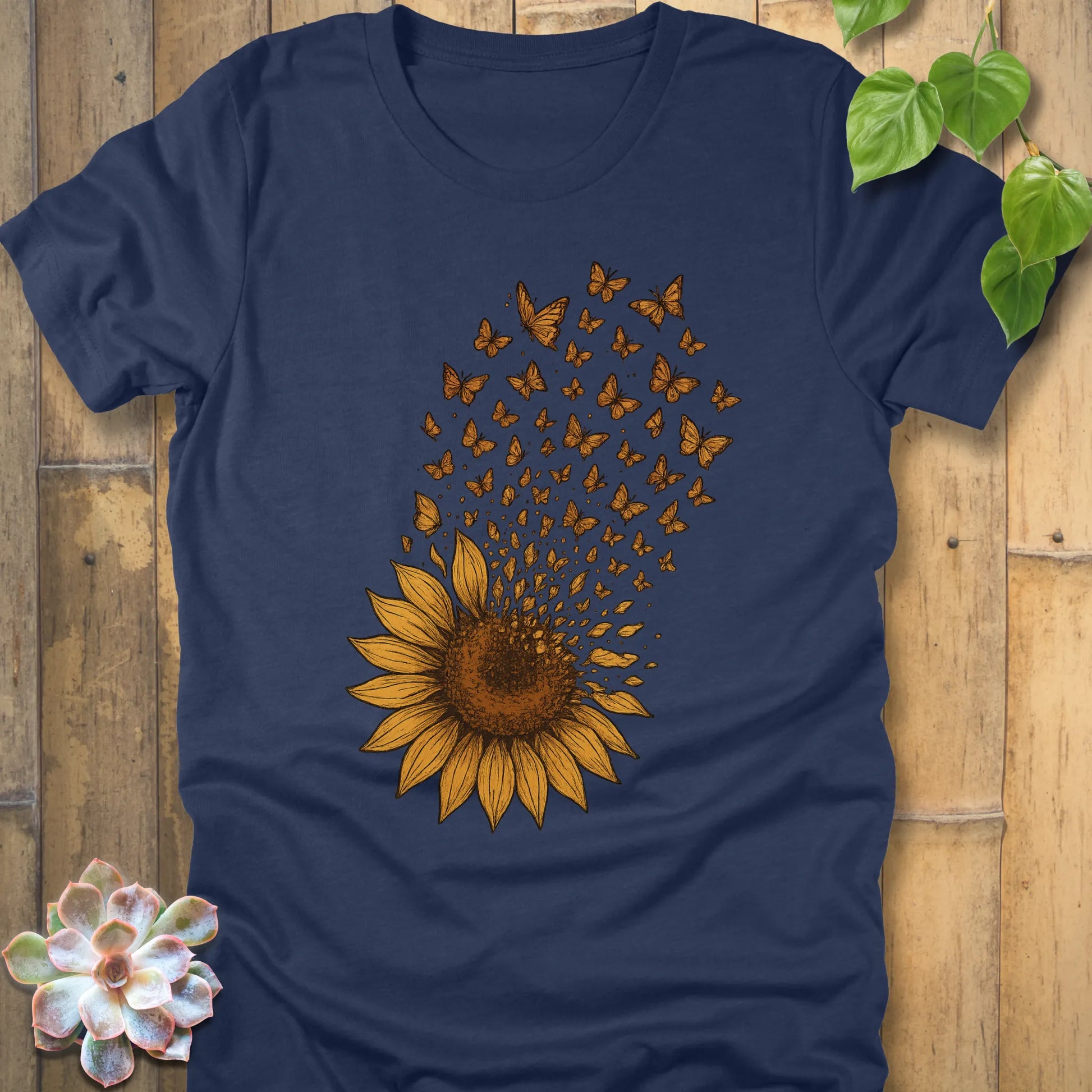 Heather Navy t-shirt with a large sunflower graphic, its petals transforming into butterflies flying upward