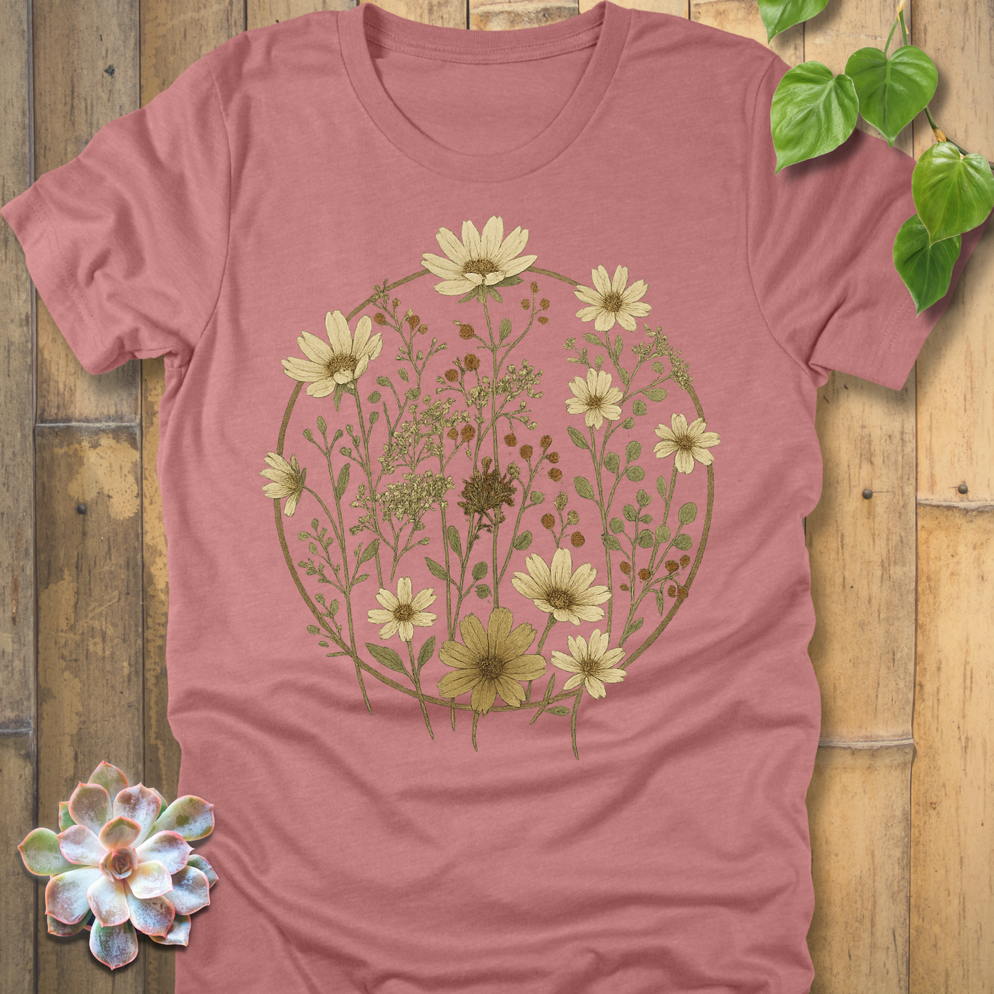 Heather mauve t-shirt with vintage botanical circle design, soft earthy floral print featuring daisies and wildflowers.
