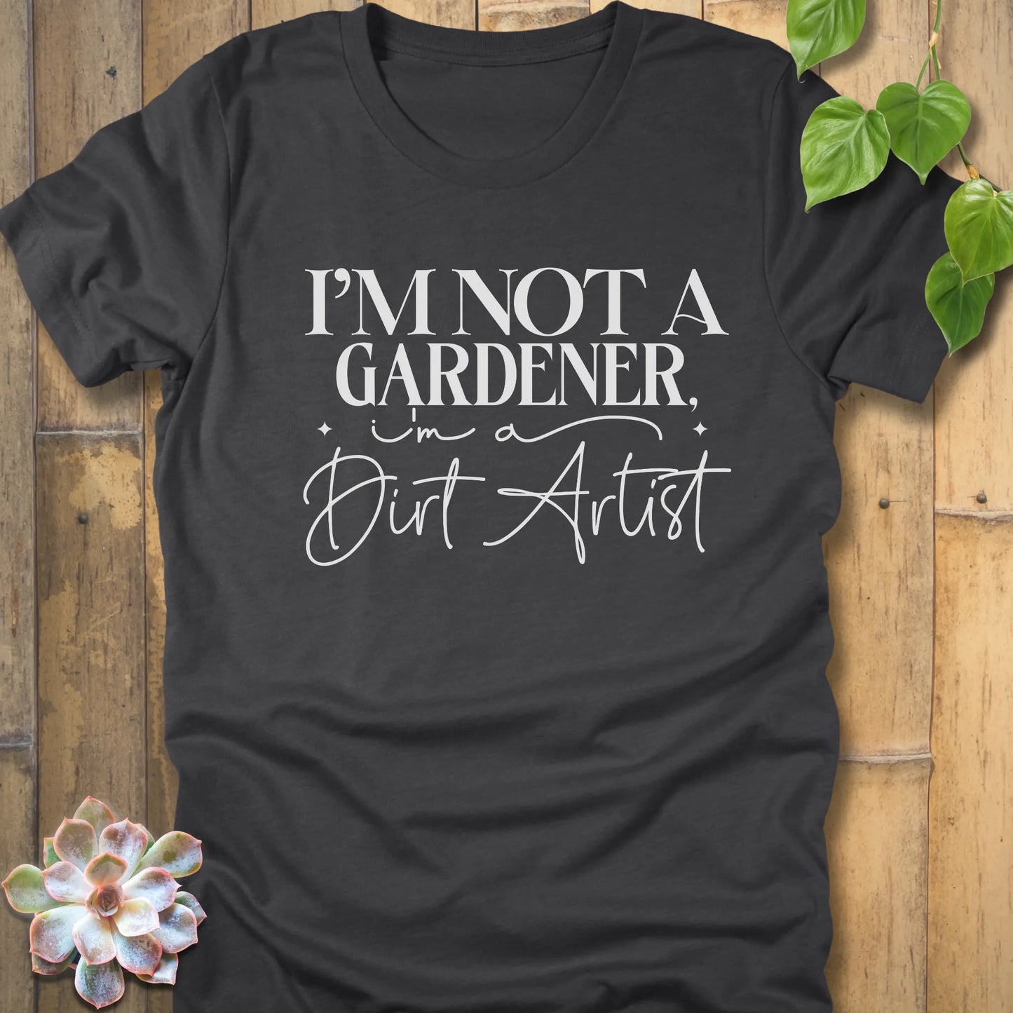 Dark Grey Heather Bella Canvas 3001 unisex t-shirt with white print: ‘I’m not a gardener, I’m a dirt artist