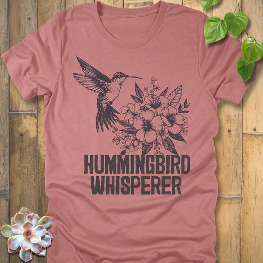 Heather mauve “Hummingbird Whisperer” T-shirt with a black floral and hummingbird print, stylish nature-inspired design on a soft cotton-blend shirt