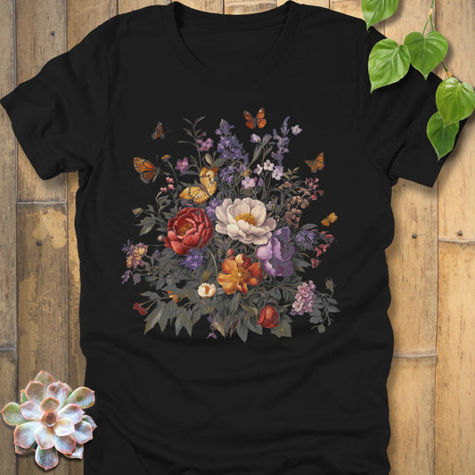 Black t-shirt featuring a detailed floral bouquet with red, white, orange, and purple flowers surrounded by butterflies