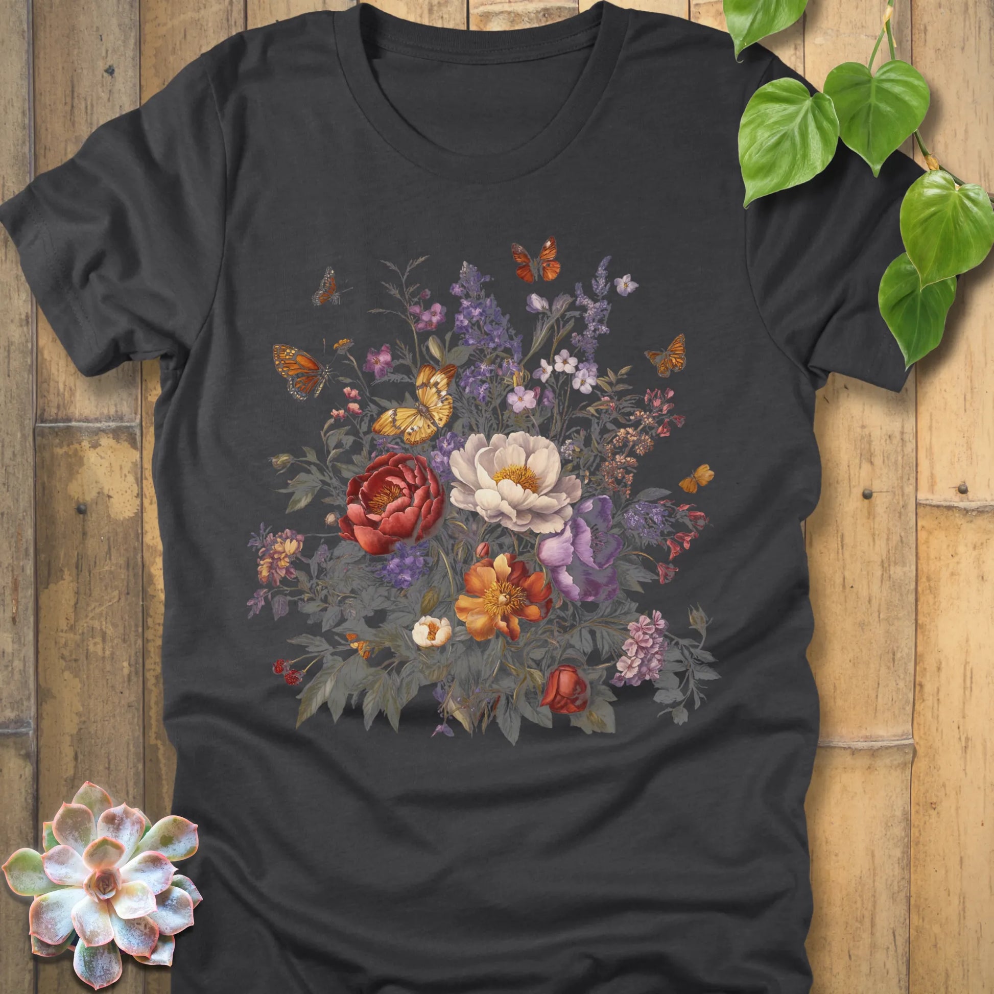 Dark Grey Heather t-shirt with a colourful garden bouquet design of red, white, orange, and purple flowers with butterflies