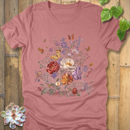 Heather Mauve t-shirt decorated with a large floral design of red, white, orange, and purple flowers with butterflies flying around