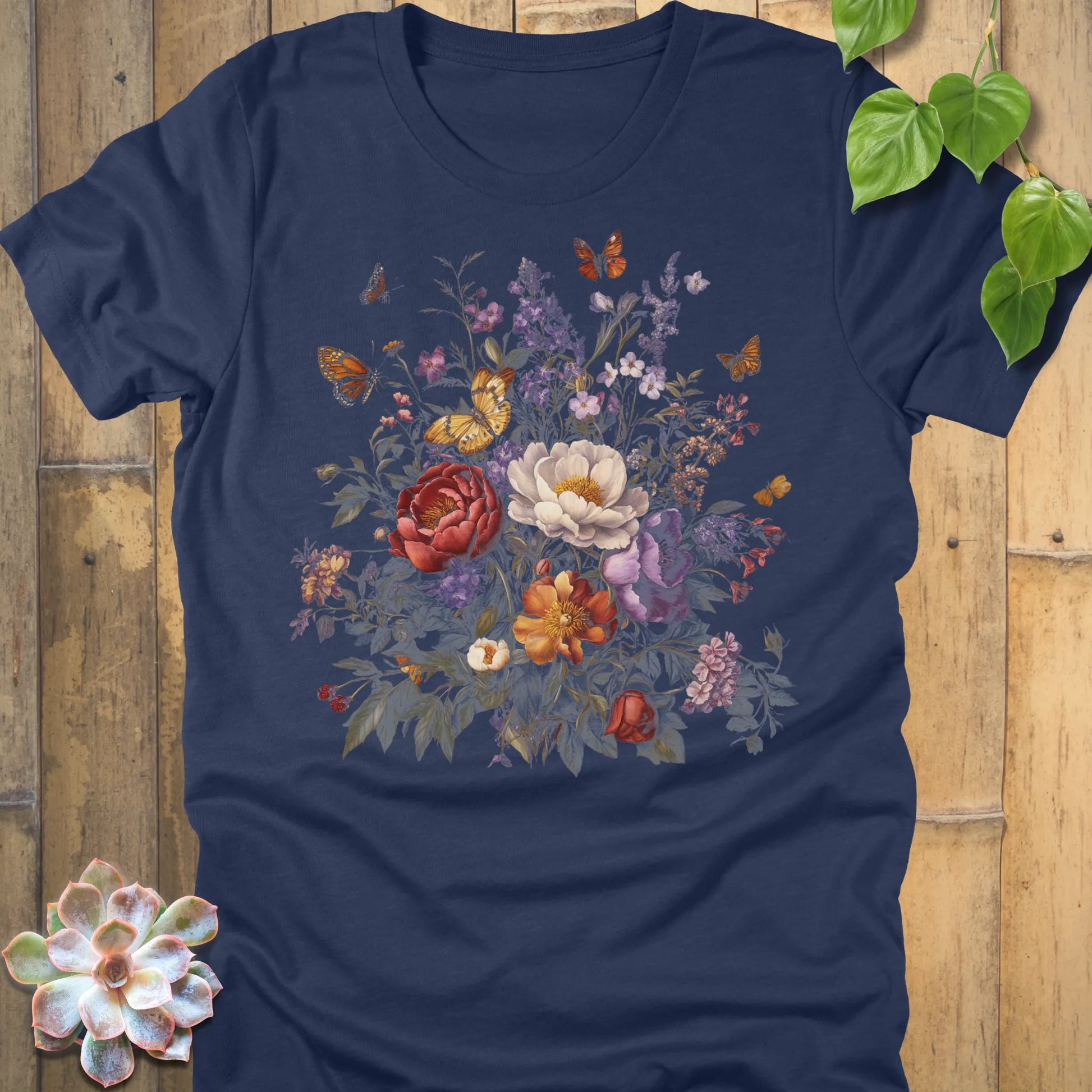 Heather Navy t-shirt with a vivid bouquet of red, white, orange, and purple flowers accented by butterflies.