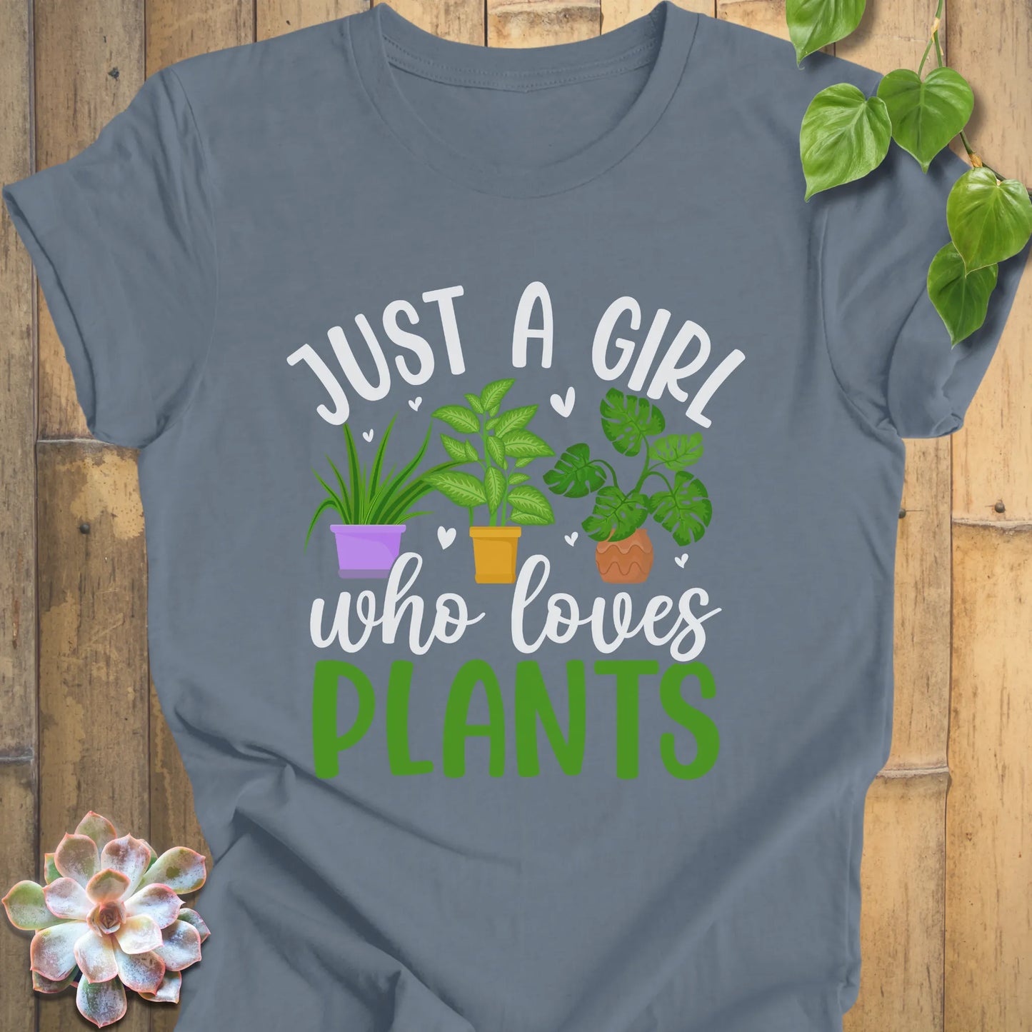 Steel Blue Bella Canvas t-shirt with Just a girl who loves plants on it with three plants in the middle