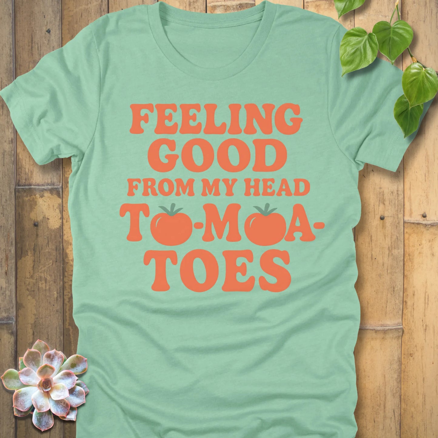 Heather Mint t-shirt featuring the design "Feeling Good from my head to-mat-toes" printed in bold orange letters