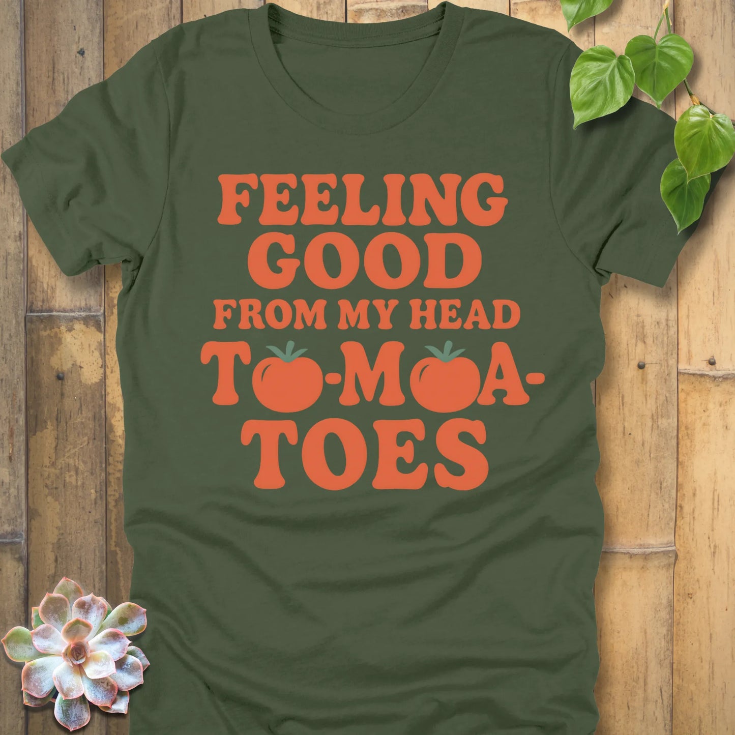 Military Green t-shirt featuring the design "Feeling Good from my head to-mat-toes" printed in bold orange letters