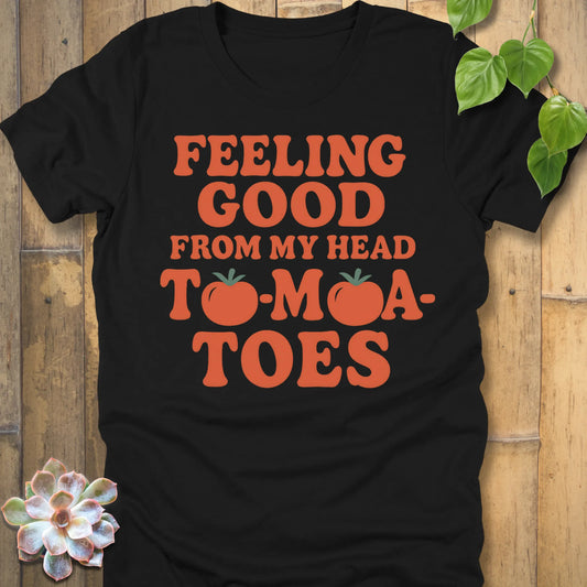 Heather Black t-shirt featuring the design "Feeling Good from my head to-mat-toes" printed in bold orange letters