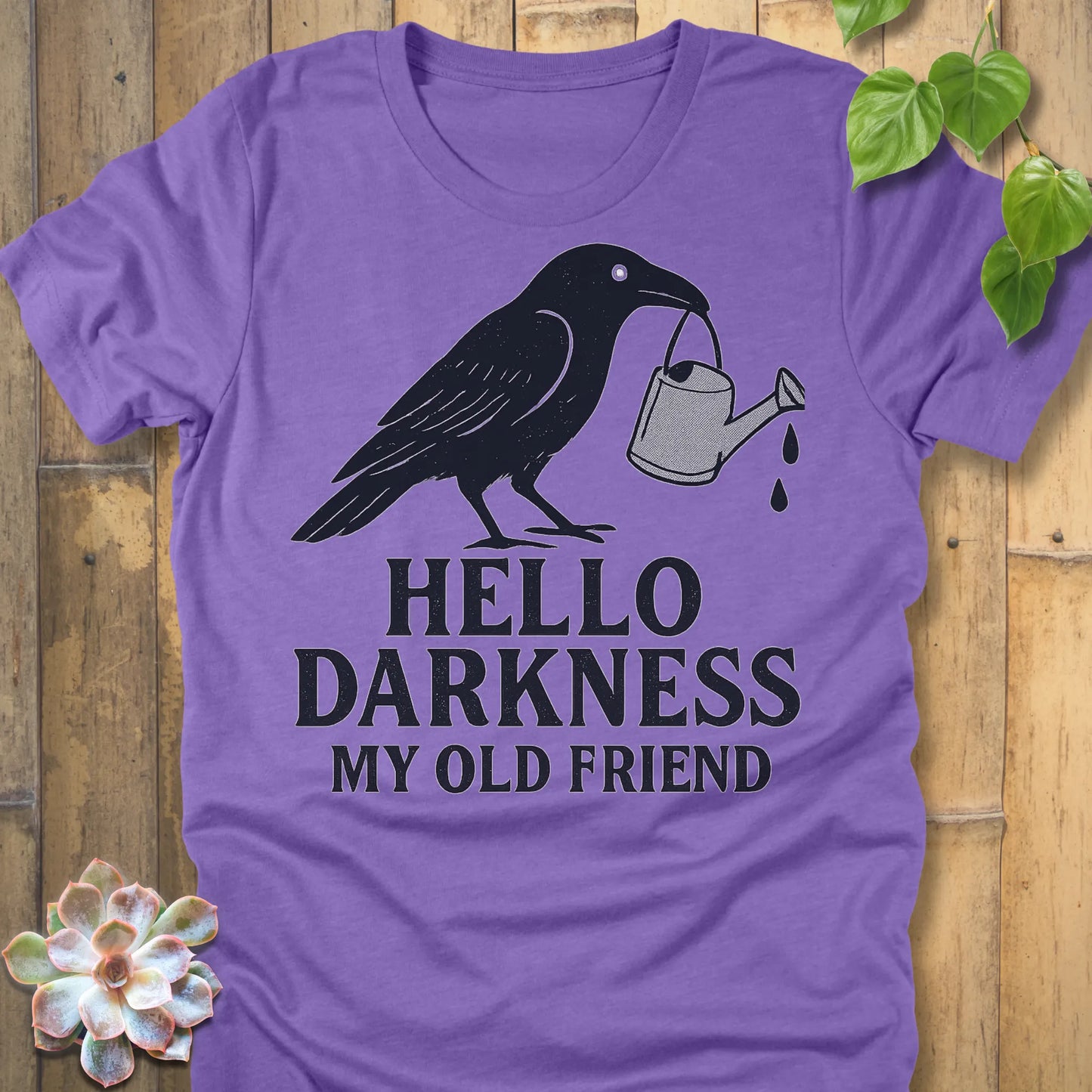 Heather Team Purple – Hello Darkness T-shirt in Heather Team Purple, bold crow and watering can graphic on Bella+Canvas 3001.