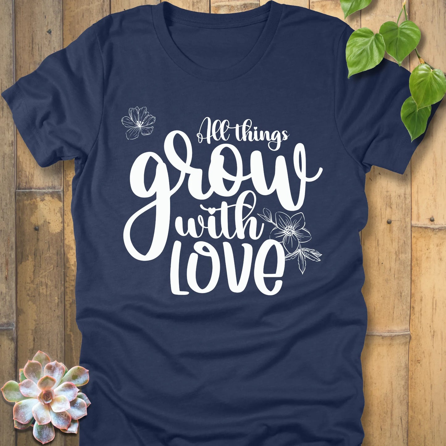 Heather navy unisex T-shirt featuring the inspirational quote ‘All things grow with love’ in bold white script with floral line art