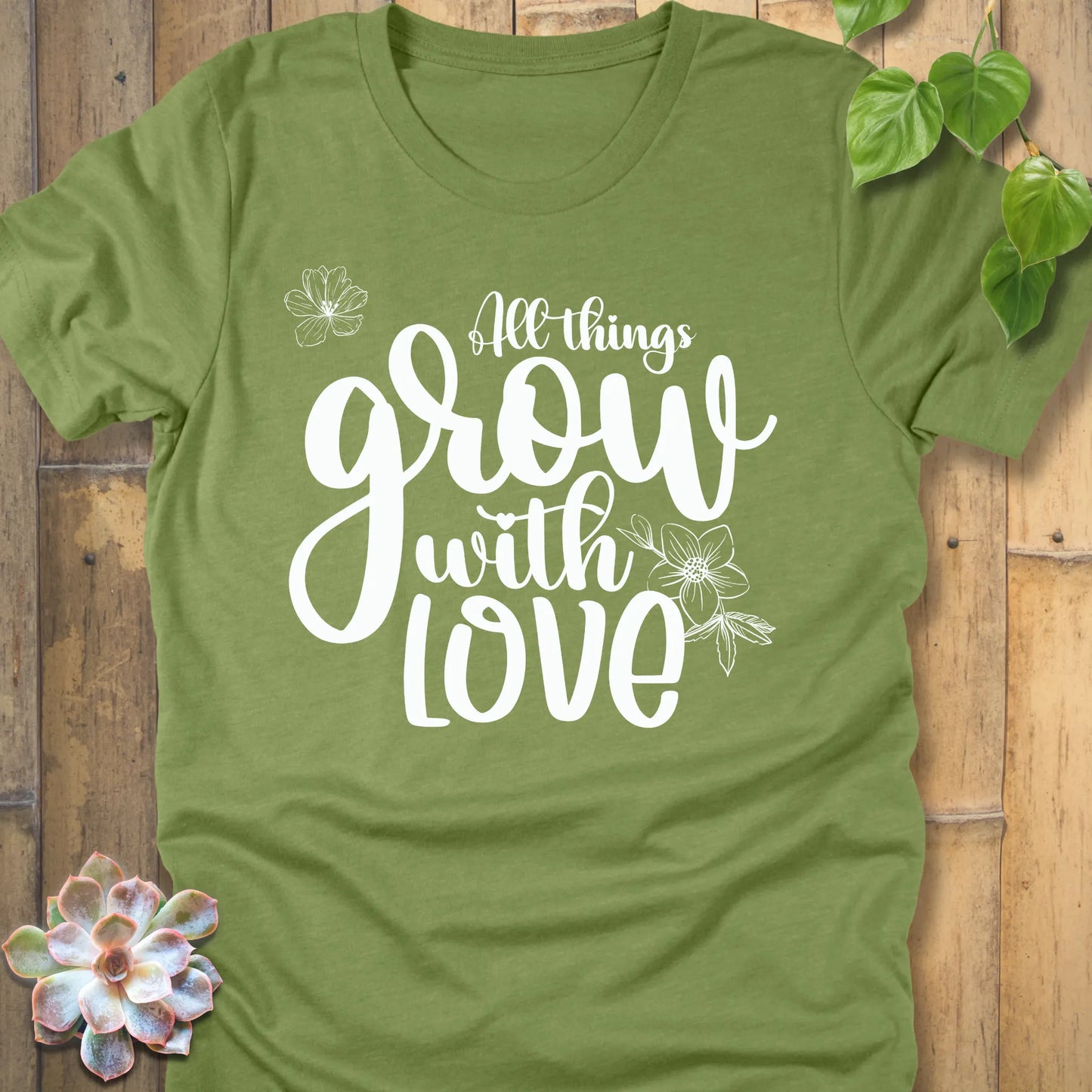 Heather green unisex T-shirt featuring the inspirational quote ‘All things grow with love’ in bold white script with floral line art