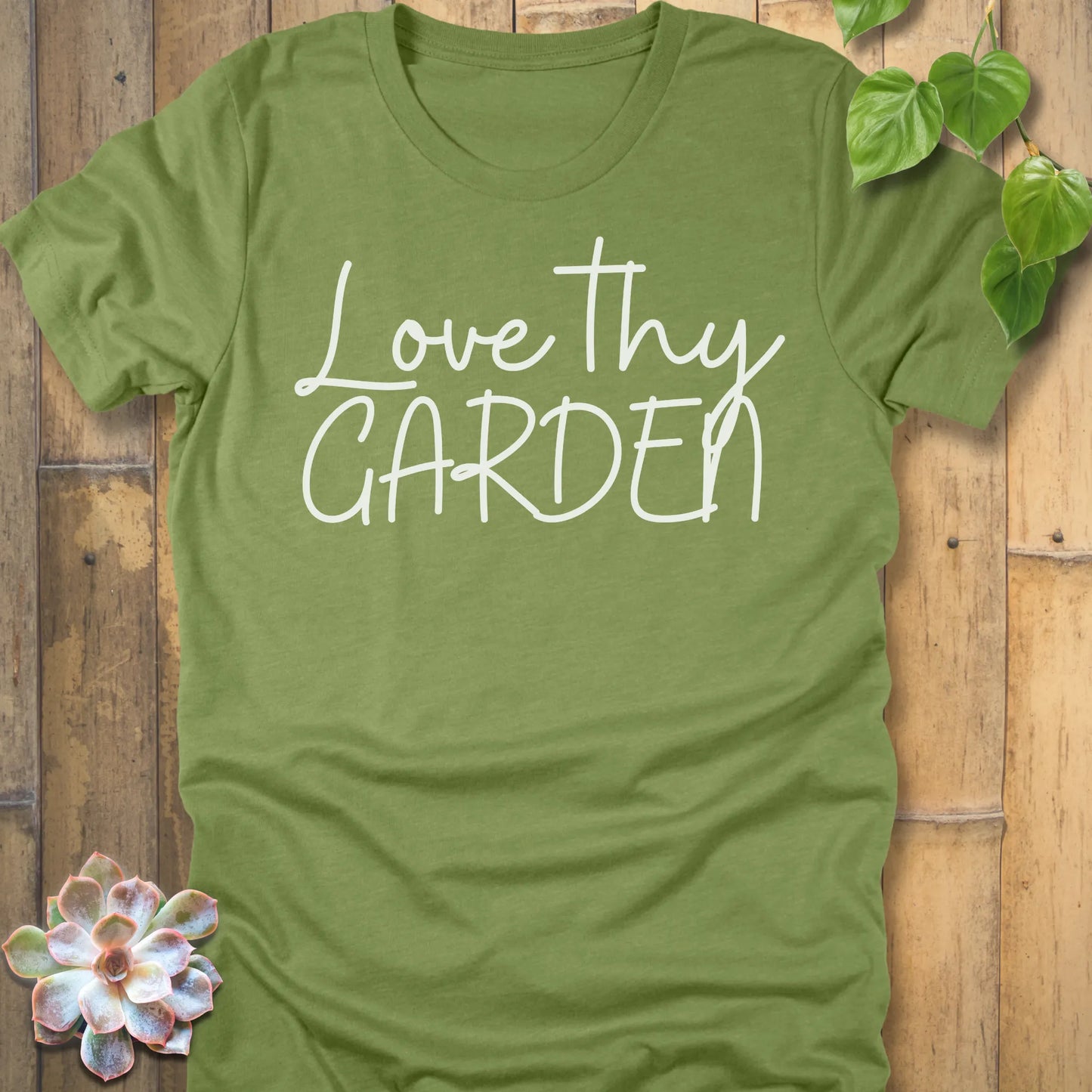 Heather  Green t-shirt featuring the design Love Thy Garden printed in white letters