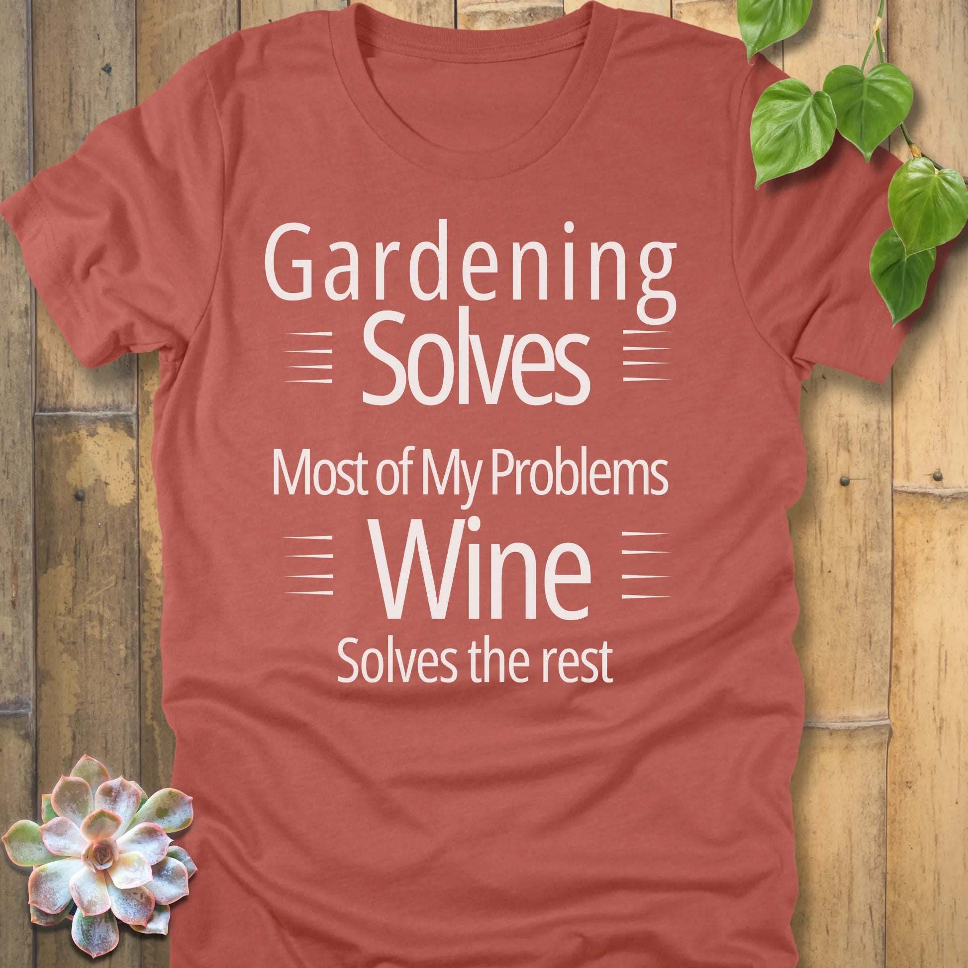 Heather clay t-shirt featuring the design Gardening solves most of my problems, wine solves the rest printed in bold black letters.