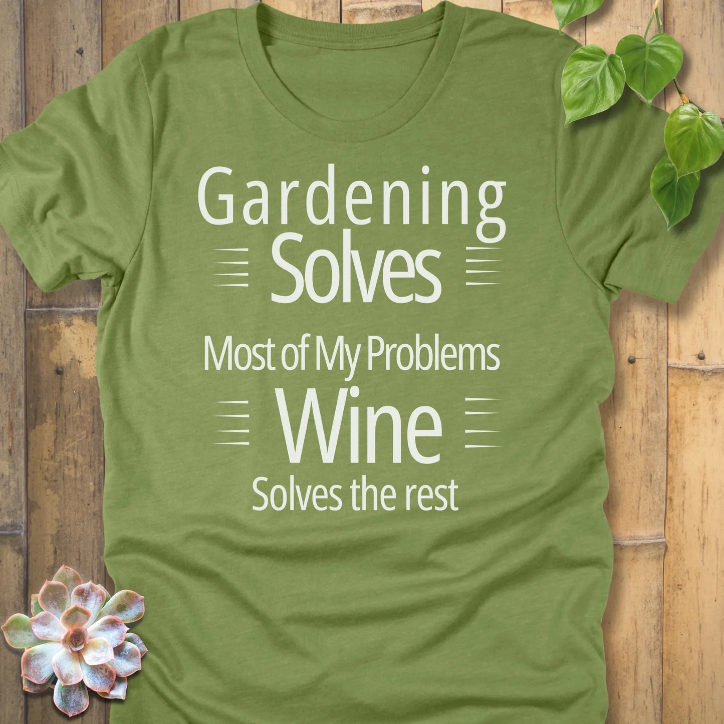 Heather green t-shirt featuring the design Gardening solves most of my problems, wine solves the rest printed in bold black letters.