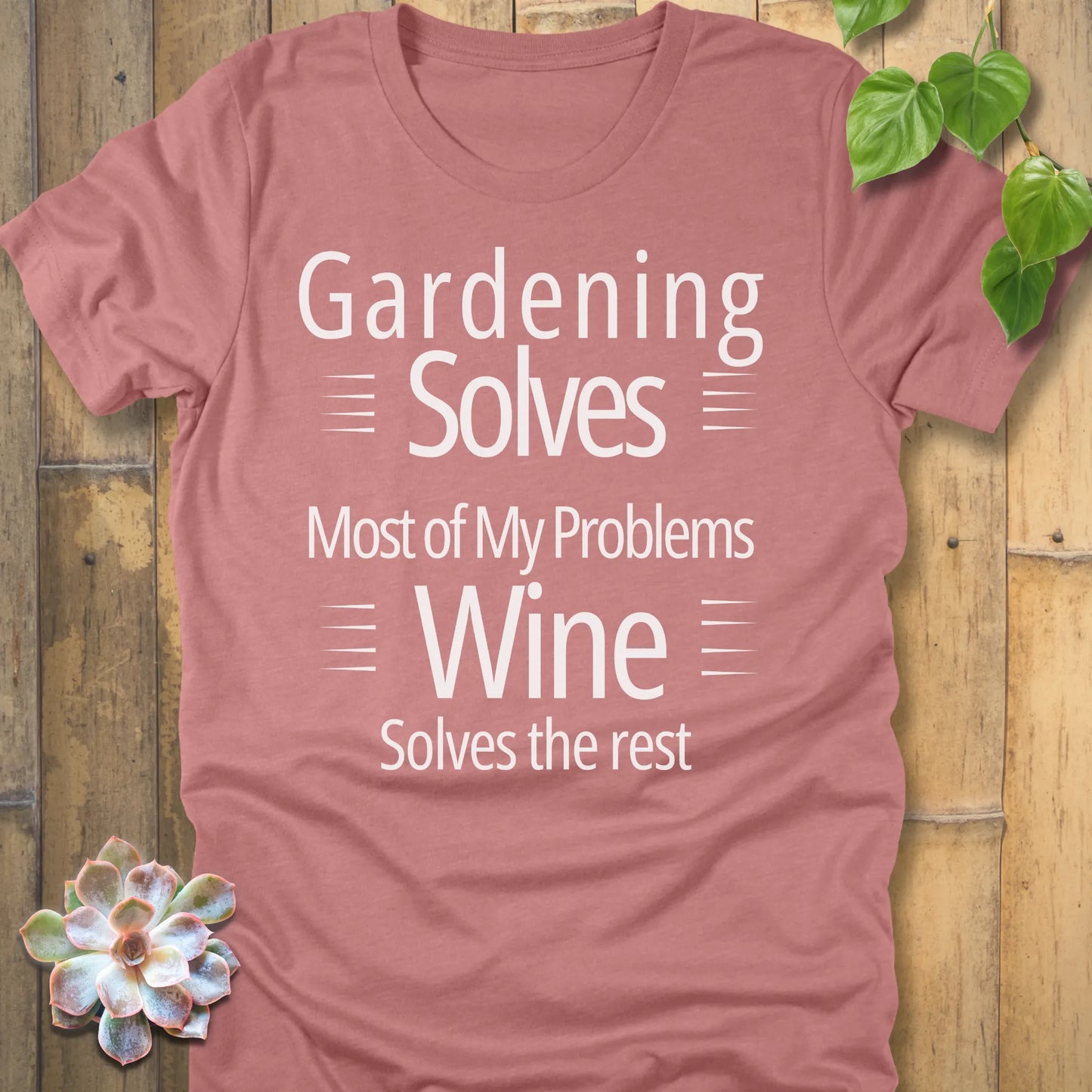 Heather peach t-shirt featuring the design Gardening solves most of my problems, wine solves the rest printed in bold black letters.