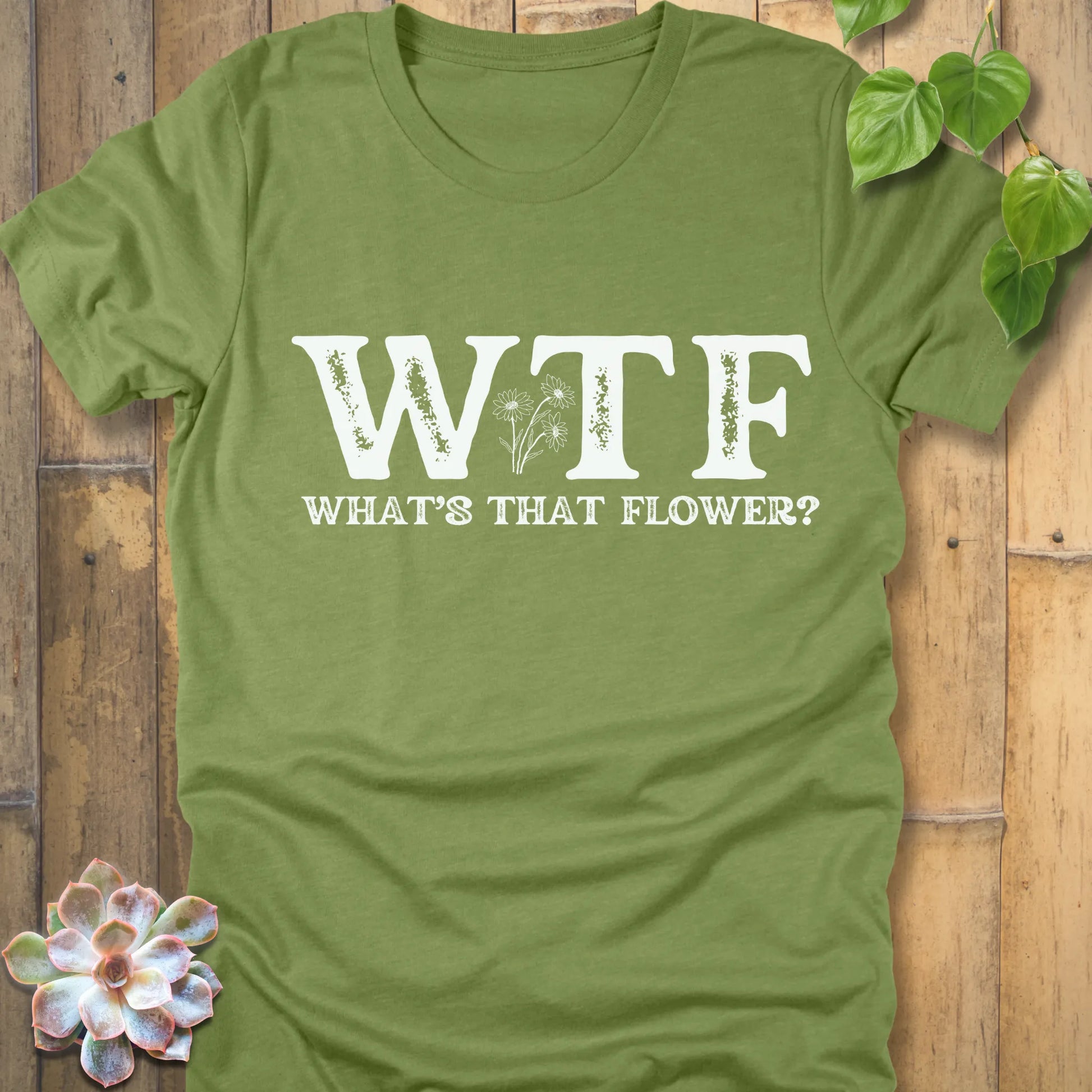 Heather Green unisex shirt with humorous WTF, What’s That Flower text design and flowers between the letters.