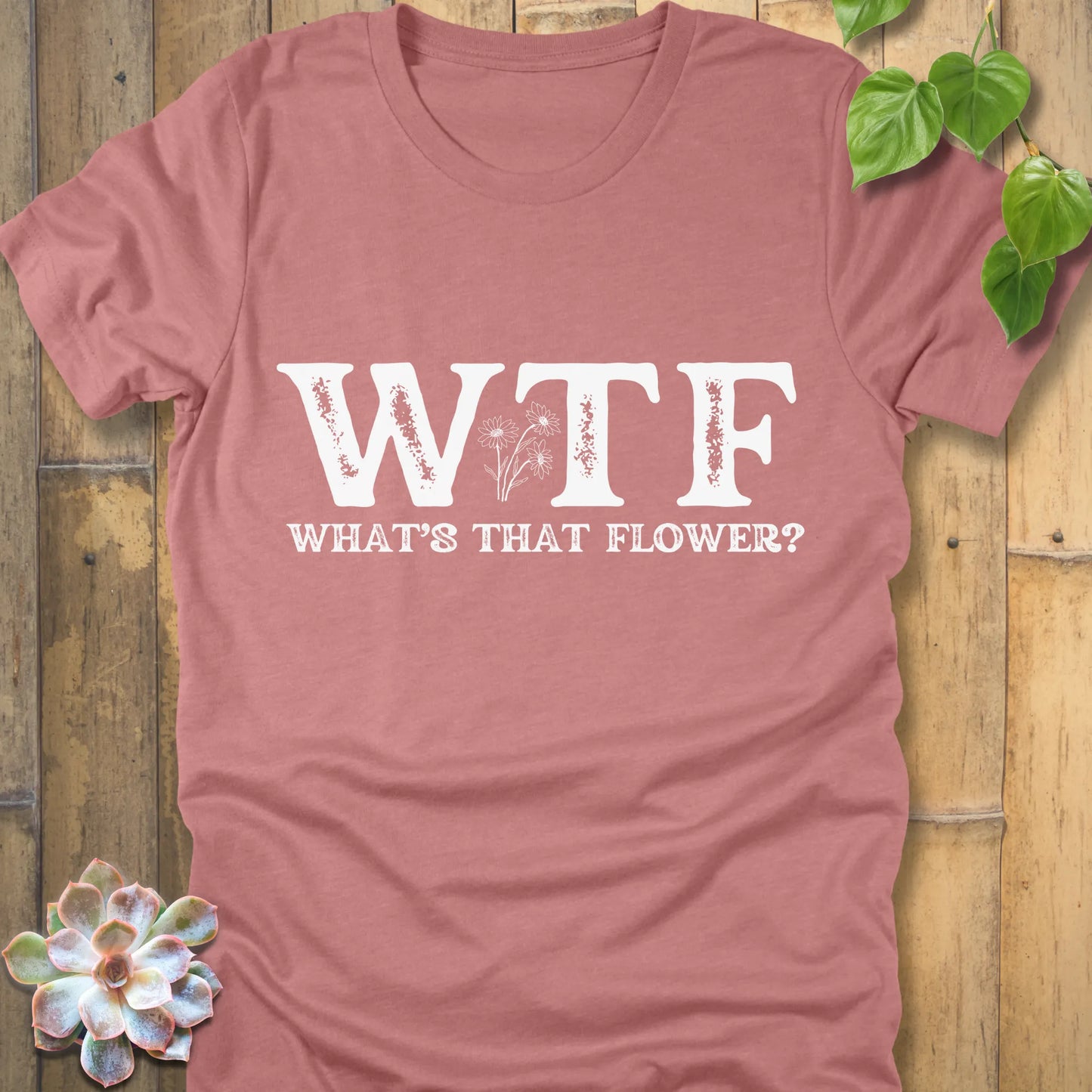 Heather Mauve graphic tee showing WTF in distressed white letters, with What’s That Flower text and floral design