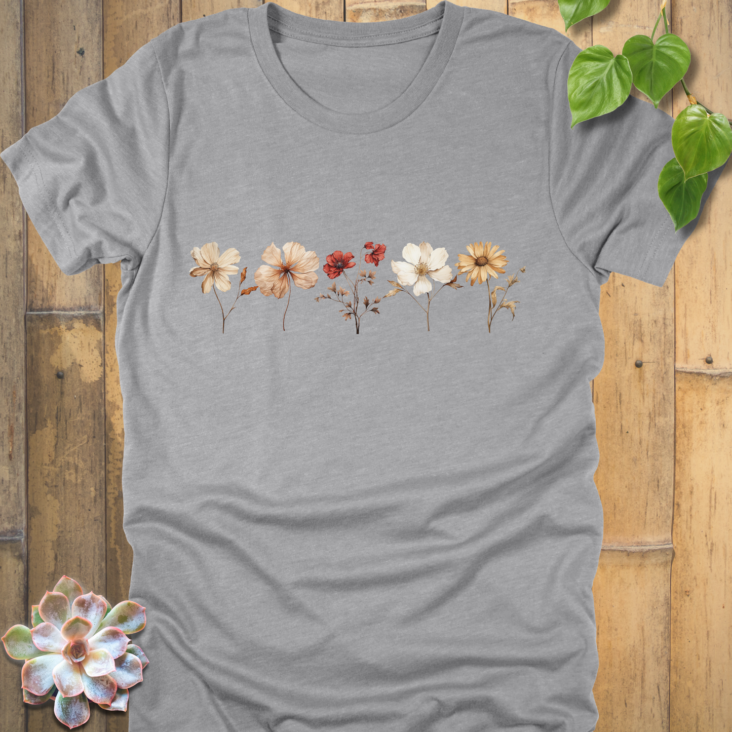 Athletic Heather t-shirt with delicate dried wildflower illustration across the chest in shades of cream, orange, and red