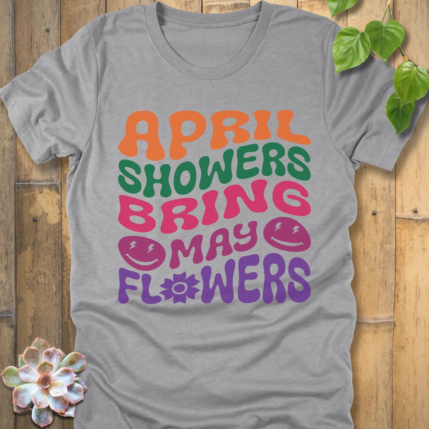 Athletic Heather t-shirt featuring the design April Shower printed in bold colorful letters, casual gardening shirt.