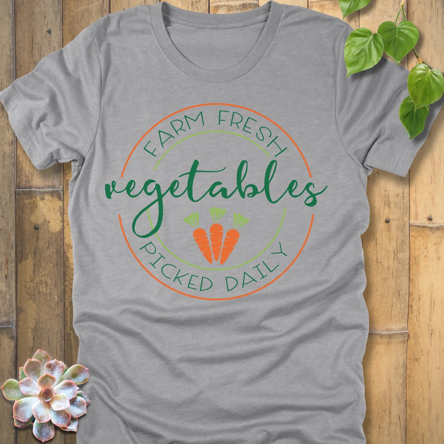 Athletic Heather t-shirt featuring the design Fresh Vegetables printed in green letters and some carrots, organic vegetable lover shirt.
