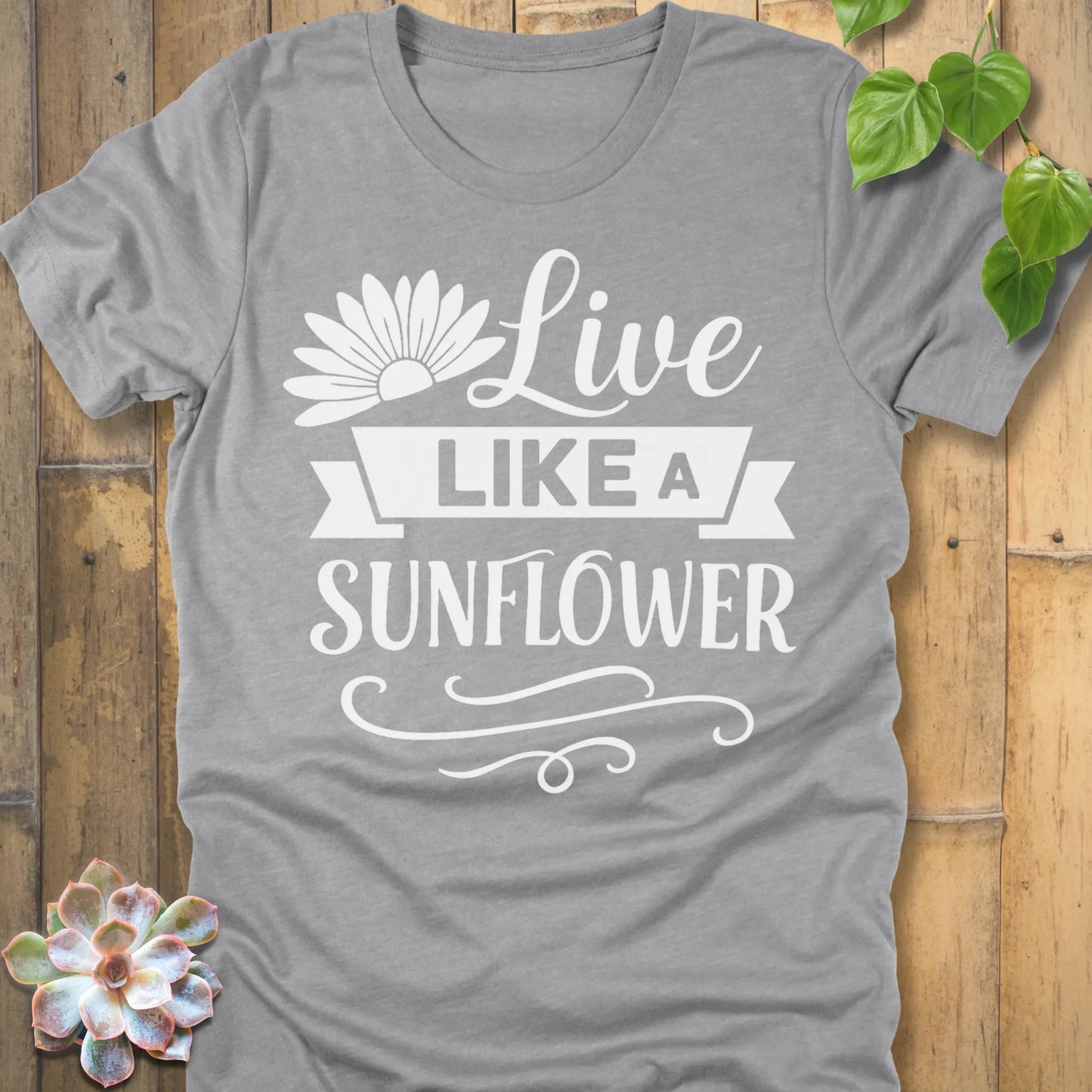 Athletic Heather t-shirt featuring the design Live Like A Sunflower printed in bold letters, motivational gardening shirt.