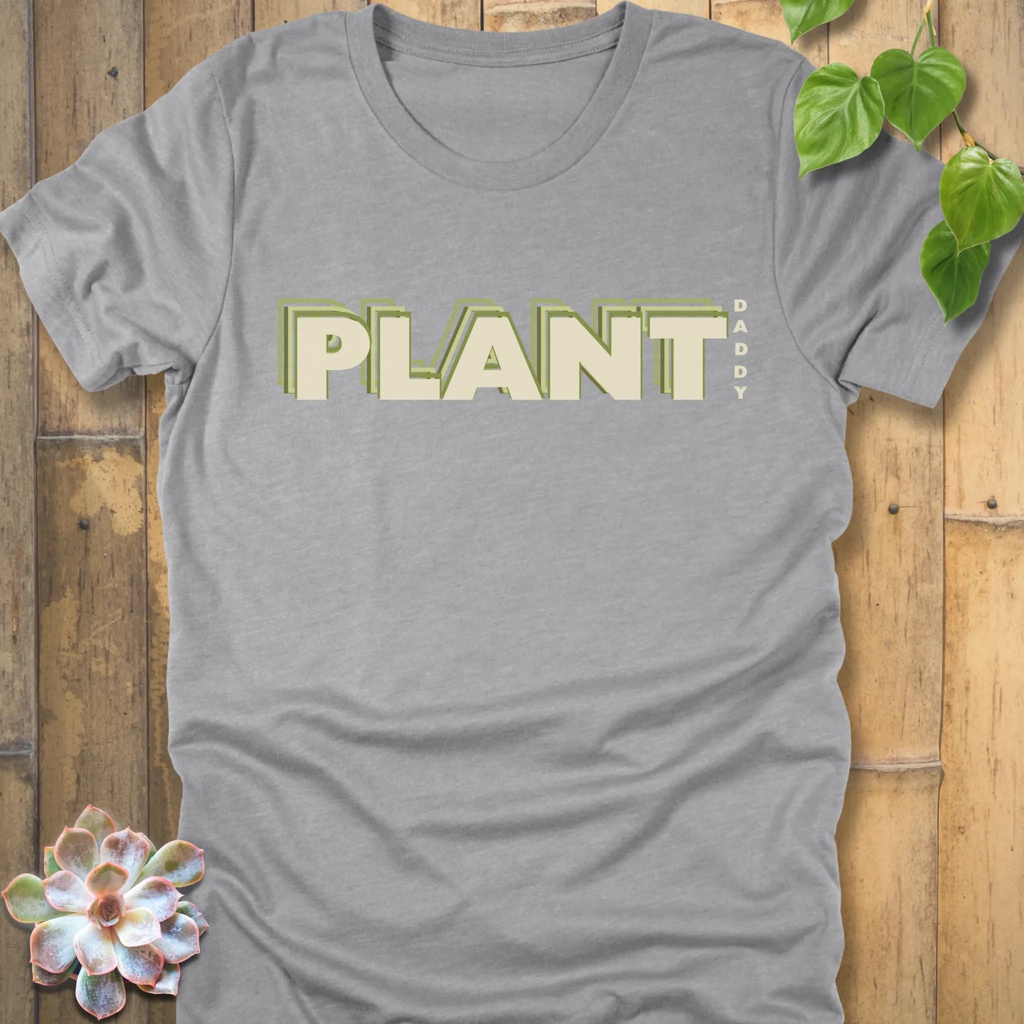 Athletic Heather t-shirt featuring the design Plant Daddy printed in bold letters, soft cotton botanical shirt.