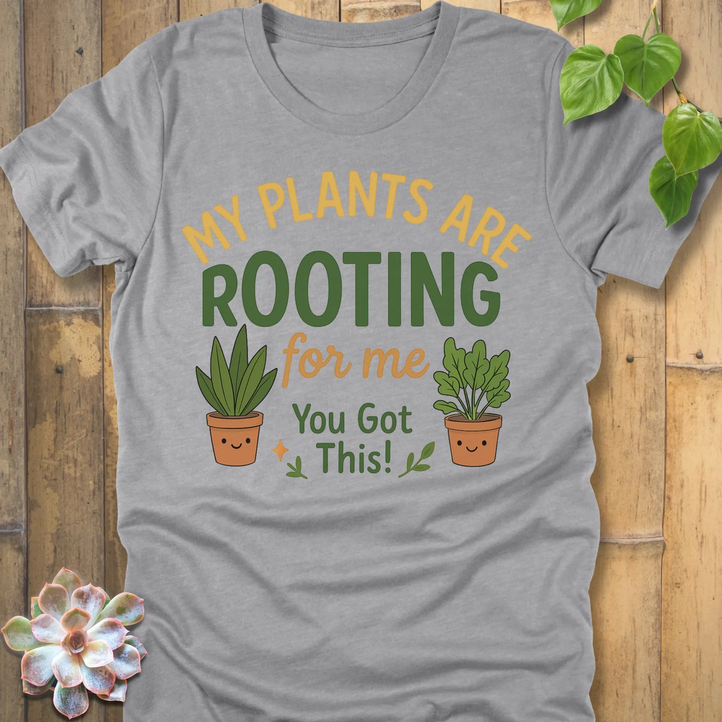 Athletic Heather t-shirt featuring the design Rooting For Me printed in bold letters and plants, gardening graphic tee.