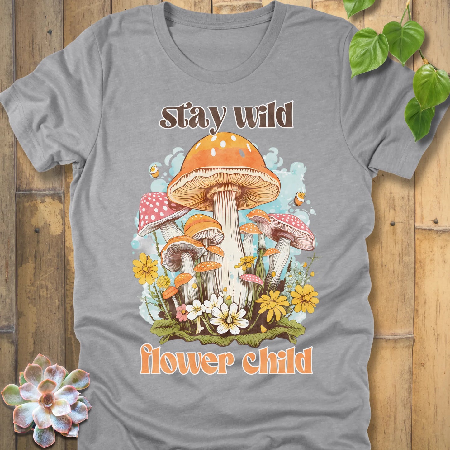 Athletic Heather t-shirt featuring the design Stay Wild Flower printed in bold letters, floral graphic tee.