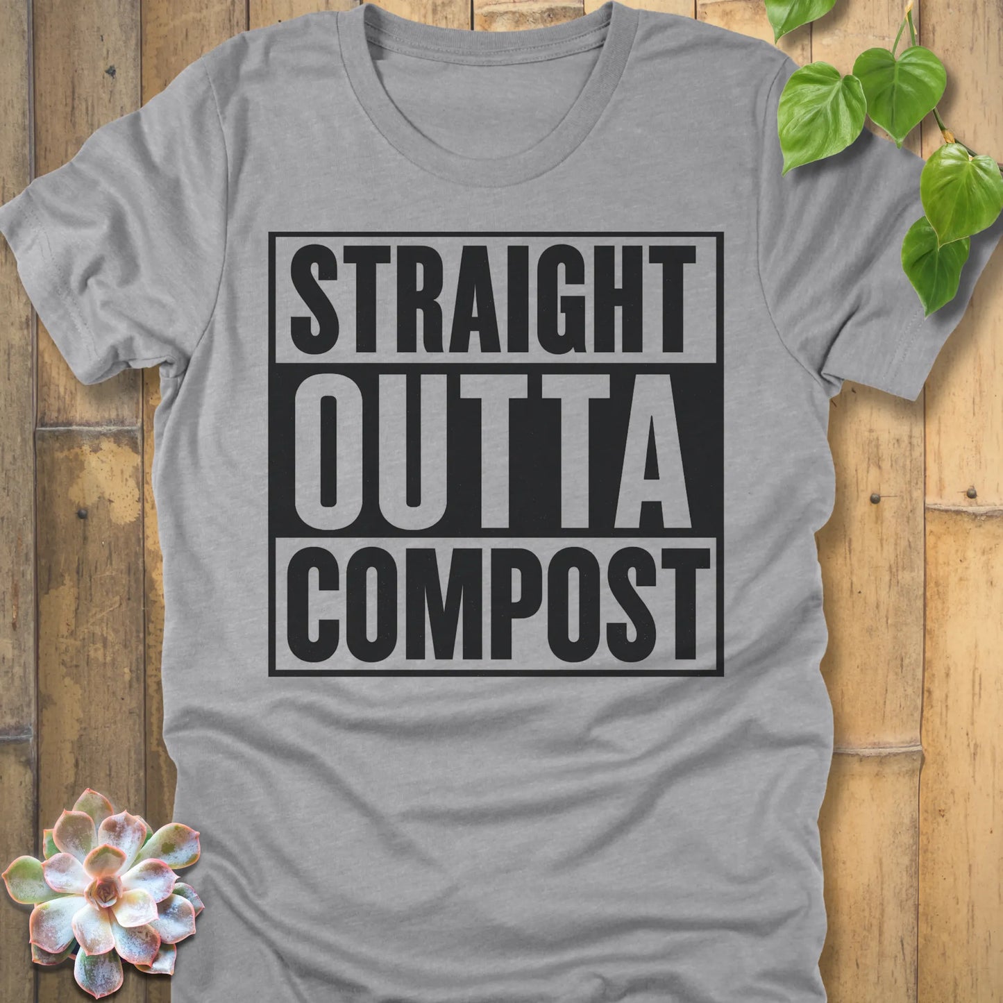 Athletic Heather t-shirt featuring the design Straight Outta Compost printed in bold letters, funny gardening shirt.
