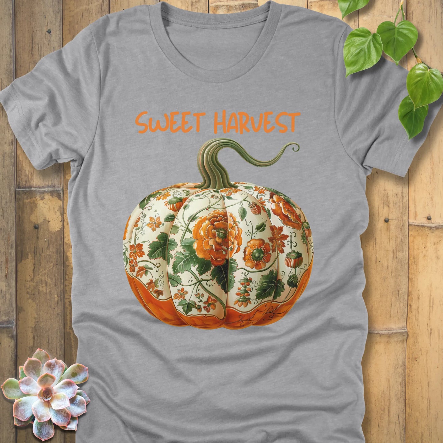 Athletic Heather t-shirt featuring the design Sweet Harvest printed in bold orange letters and a halloween pumpkin design