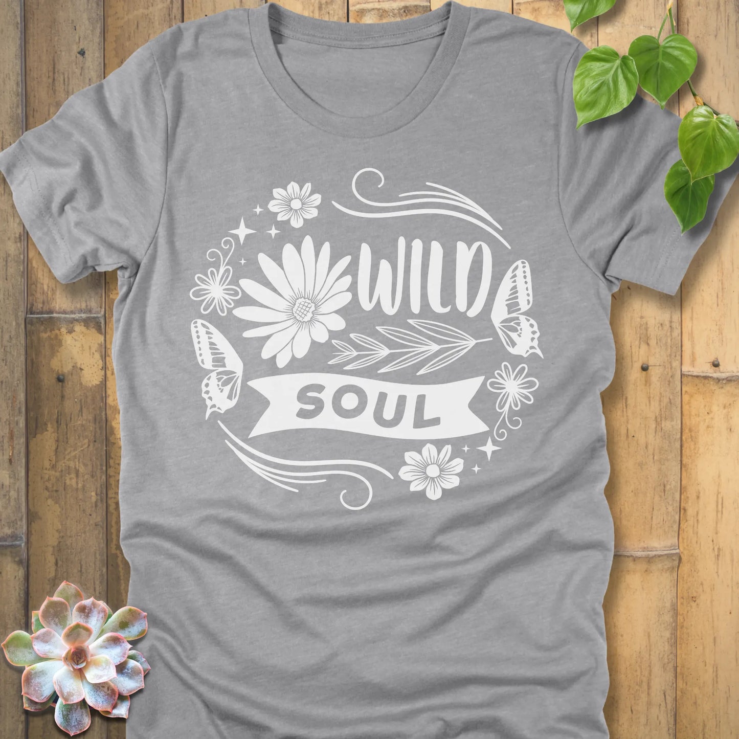Athletic Heather t-shirt featuring the design Wild Soul printed in bold letters and flower, butterfly