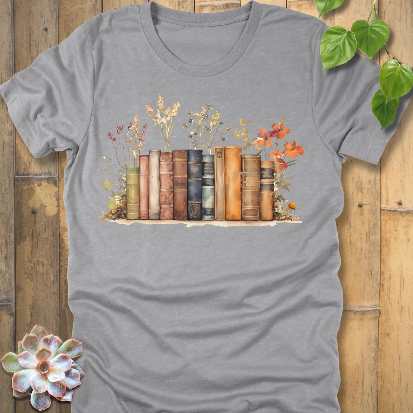 Athletic Heather t-shirt featuring the design Wildflower Library printed with books and plants, floral graphic tee for plant lovers.