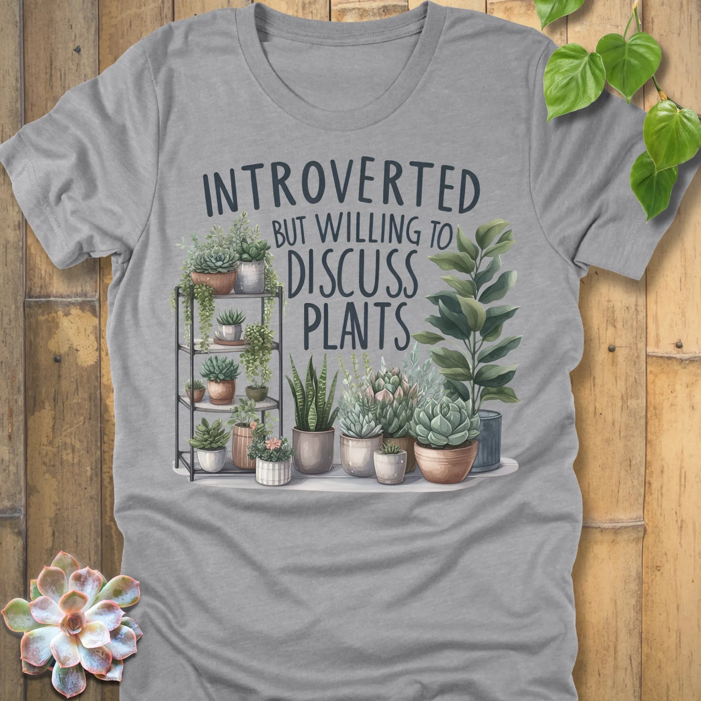 Athletic Heather t-shirt featuring the design Willing To Discuss Plants printed in bold black letters, funny plant lover shirt.
