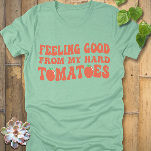 Heather Mint t-shirt featuring the design "Feeling Good from my hard tomatoes" printed in bold orange letters