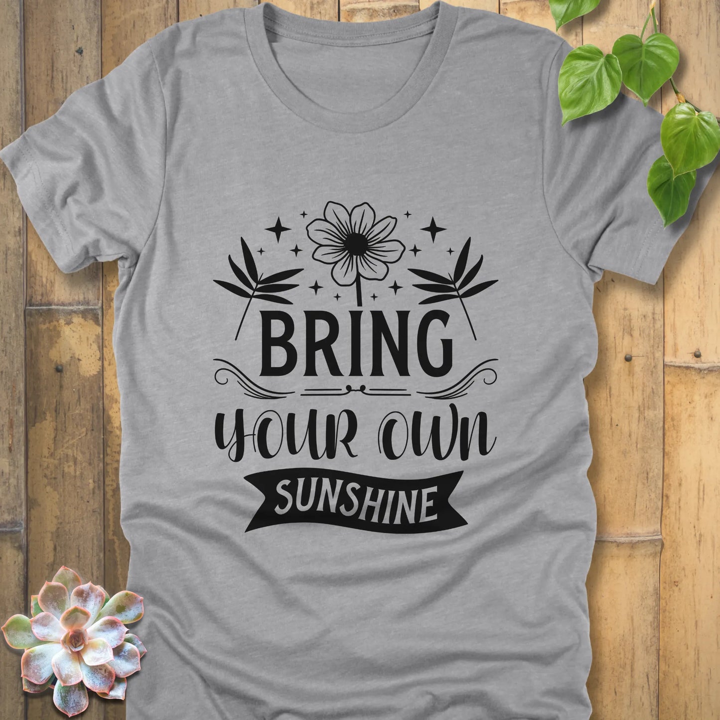 Athletic grey t-shirt featuring the design "Bring Your Own Sunshine" printed in black lette and flower