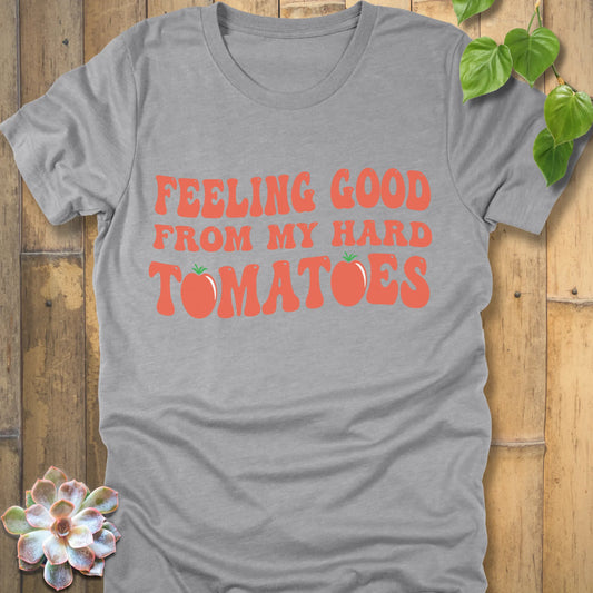 Athletic grey t-shirt featuring the design "Feeling Good from my hard tomatoes" printed in bold orange letters