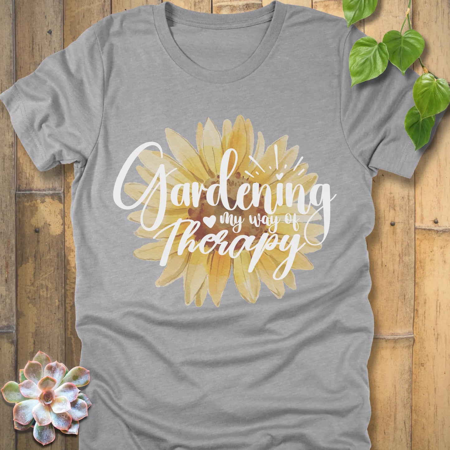 Athletic heather t-shirt featuring the design Gardening my way of therapy with a sunflower in the center.