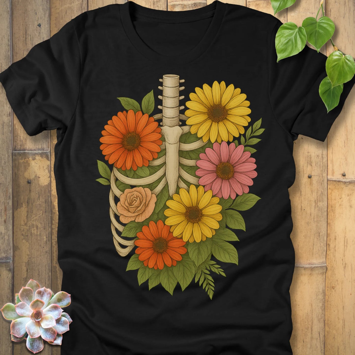 Black t-shirt featuring the design Gerbera Bones halloween floral skeleton graphic tee.