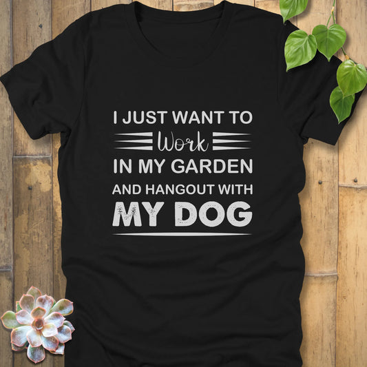 Black t-shirt featuring the design "I just want to work in my garden and hangout with my dog" printed in white letters