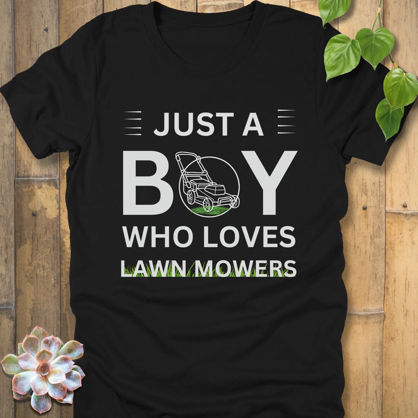 Black t-shirt featuring the design Just a Boy who loves lawn mowers printed with a lawn mower in the center